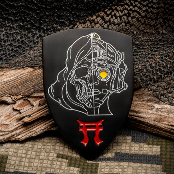 Shield-shaped challenge coin featuring a split cyborg skull line drawing and a red torii gate symbol on a black background.