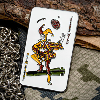 Rectangular Jokers Wild challenge coin featuring a jester riding a missile on a white enamel background.