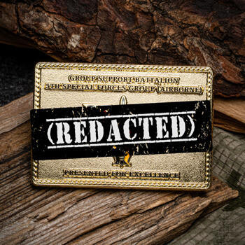 Rectangular gold challenge coin for Group Support Battalion 5th Special Forces Group (Airborne) featuring a rope border and recessed sandblast background.