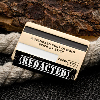 Gold rectangular credit card style challenge coin featuring black and white enamel accents, text 'A Standard Built In Gold', and 'Crew 202'.