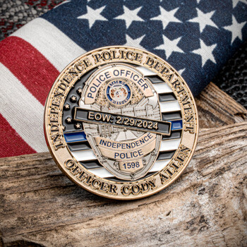Gold and blue memorial challenge coin for Independence Police Officer Cody Allen with an American flag and thin blue line design.