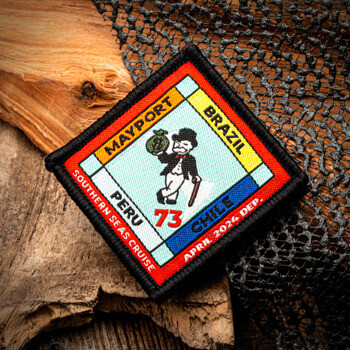 Square embroidered patch featuring a board game theme with Mayport, Brazil, Peru, Chile, and a character holding a money bag.