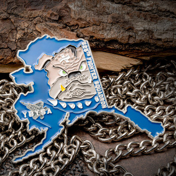 Alaska shaped lapel pin featuring a bulldog mascot, F-22 Raptor silhouette, and 525th Fighter Squadron text on a silver chain background.