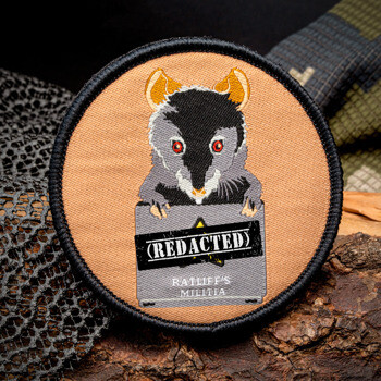 Embroidered circular patch featuring a possum peeking over a box with the text Ratliff's Militia and Redacted.