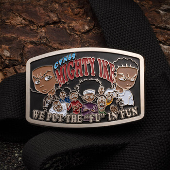 Rectangular belt buckle featuring CVN 69 Mighty Ike text and Boondocks-style character illustrations on a black background.