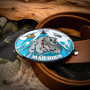 Oval belt buckle featuring a bulldog with a wrench, military helicopters, and snowy mountains with the text Mad Dogs.