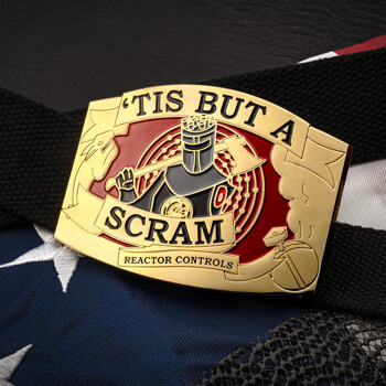 Gold belt buckle with 'Tis But A Scram' text and knight with axe on red background, displayed on a black strap over an American flag.