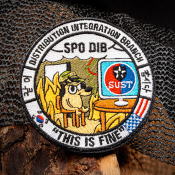 Circular embroidered patch featuring the 'This is Fine' dog meme, SPO DIB text, and Sustenance logo on a computer monitor.