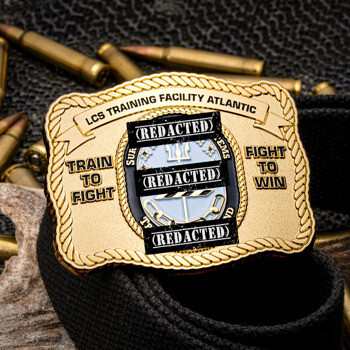Belt buckle shaped challenge coin for LCS Training Facility Atlantic with rope border, displayed on a belt strap alongside loose ammunition.