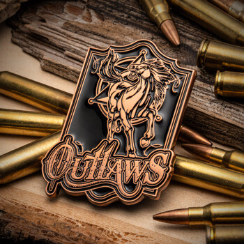 Outlaws custom lapel pin in copper and black, featuring a rearing horse and star emblem, displayed among rifle bullets on wood.