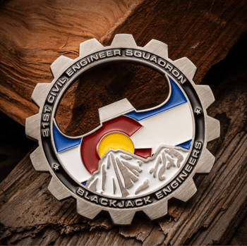 Gear-shaped challenge coin bottle opener for the 21st Civil Engineer Squadron Blackjack Engineers featuring a Colorado flag and mountain design.