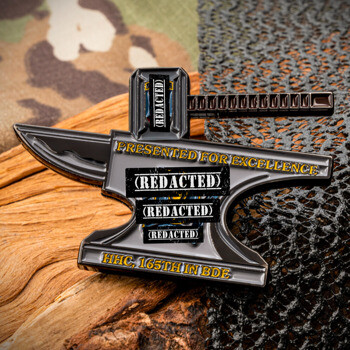 Anvil-shaped challenge coin featuring the text HHC 165th IN BDE and Presented for Excellence with black enamel details.