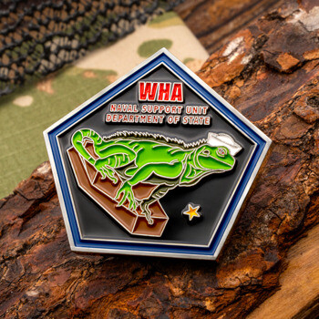 Pentagon-shaped WHA Naval Support Unit Department of State challenge coin featuring a green iguana wearing a sailor hat, set against a wooden bark background.