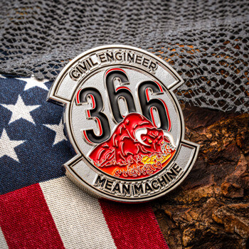 Custom challenge coin featuring the text Civil Engineer 366 Mean Machine with a red bull design, displayed over an American flag and textured bark.