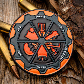 Black and orange gear-shaped challenge coin displaying military maintenance fields including Egress, Fuels, Metals Tech, Props, AFE, and AGE.