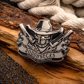 Roughnecks lapel pin featuring a skull wearing a cowboy hat with crossed rifles, presented for excellence, shown on a piece of wood.
