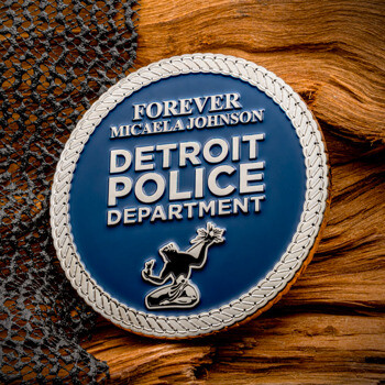 Custom blue and silver Detroit Police Department challenge coin featuring 'Forever Micaela Johnson' text, a silver rope border, and a statue emblem.