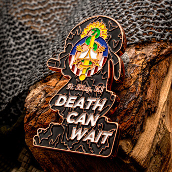 Custom shaped challenge coin featuring Ft. Riley, KS medical insignia and the bold text 'Death Can Wait' on a black background, placed on a wood log.
