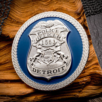 Circular challenge coin featuring a silver Detroit police officer shield badge 1563 on a blue background with a rope border.