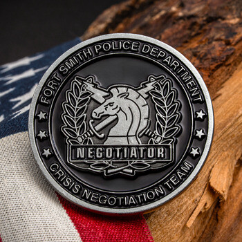 Fort Smith Police Department Crisis Negotiation Team challenge coin with chess knight and lightning bolts against an American flag.