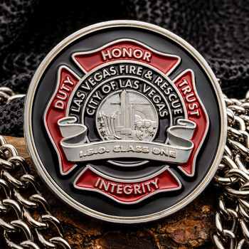 Las Vegas Fire & Rescue challenge coin featuring a red Maltese cross design with core values over silver chains.