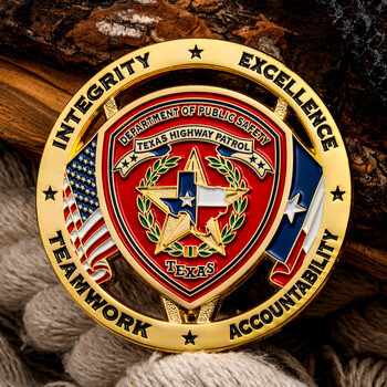 Gold Texas Highway Patrol challenge coin featuring the state emblem, American and Texan flags, and department core values.
