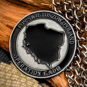 Silver military challenge coin for FOS Swietoszow, Poland Operation EADR featuring a map of Poland on a camouflage and wood background.