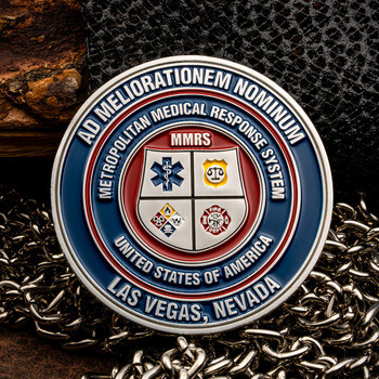 Metropolitan Medical Response System Las Vegas challenge coin featuring an enameled emblem with emergency service icons on a leather and chain background.