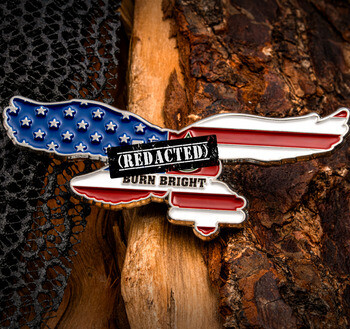 Enamel lapel pin shaped like a soaring eagle decorated with American flag stars and stripes pattern and reading Burn Bright.