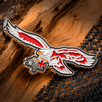 Enamel lapel pin shaped like a flying eagle with red and white wings clutching a medical caduceus and red cross emblem.