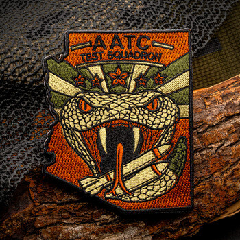 Custom embroidered patch shaped like Arizona featuring a coiled rattlesnake with bullets and AATC Test Squadron lettering.