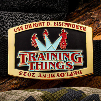 USS Dwight D. Eisenhower belt buckle with Training Things design and Deployment 2023 text on black canvas strap.