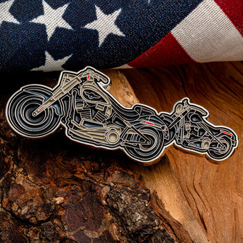 Custom enamel lapel pin shaped like cruiser motorcycles set against a rustic wood background and an American flag.