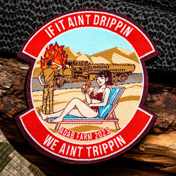 Embroidered morale patch featuring a desert scene with a pinup woman on a lounge chair and text reading If It Aint Drippin We Aint Trippin.