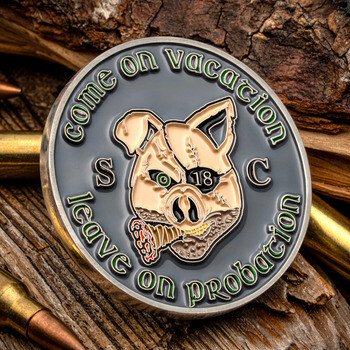 Custom round challenge coin featuring a stylized boar with an eye patch, cigar, and text reading Come on Vacation, Leave on Probation.