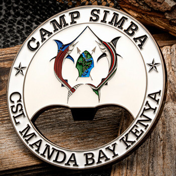 Bottle opener challenge coin engraved with Camp Simba CSL Manda Bay Kenya featuring twin marlin fish around a spearhead emblem.
