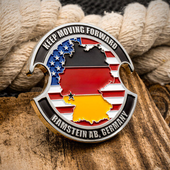 Cutout challenge coin featuring Ramstein AB, Germany text with a German flag silhouette over an American flag background.
