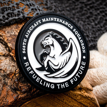 568th Aircraft Maintenance Squadron challenge coin featuring an embossed Pegasus emblem and black border.