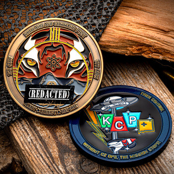 Front and back view of a Kirtland AFB Command Post challenge coin featuring a tiger motif and operational emblems on a rustic wood background.