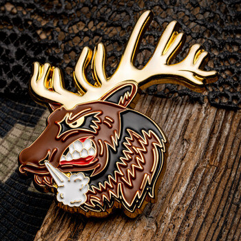 Enamel lapel pin featuring an aggressive cartoon elk head with golden antlers, gritted teeth, and snorting steam.