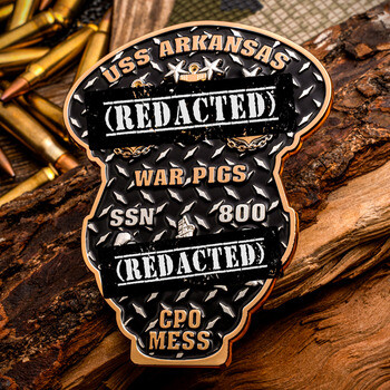 Custom shaped challenge coin for USS Arkansas SSN 800 CPO Mess featuring diamond plate texture and REDACTED bars, set against wood and ammunition.