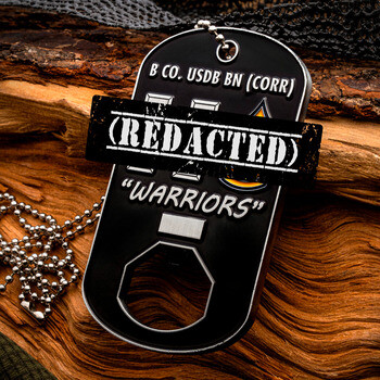 Custom black dog tag challenge coin bottle opener for B Co. USDB BN Warriors on a ball chain resting on rustic wood.
