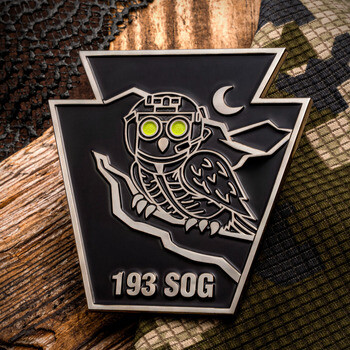 Keystone-shaped challenge coin for 193 SOG featuring a tactical night-vision owl design against a black matte background.