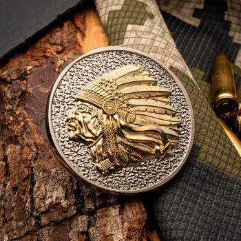 Dual-tone challenge coin featuring a raised golden Native American chief in a feathered headdress against a textured silver background.