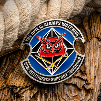 Cutout challenge coin for the 693d Intelligence Support Squadron featuring a red horned owl emblem and motto.