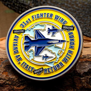 Military challenge coin for the 31st Fighter Wing at Aviano AB Italy, showing blue fighter jets and yellow accents.