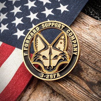 F Forward Support Company 3-29FA military challenge coin featuring a cutout fox head emblem, displayed over an American flag and rustic wood.