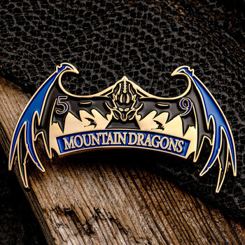 Enamel lapel pin shaped like a winged dragon with 5-9 Mountain Dragons text in blue and gold.