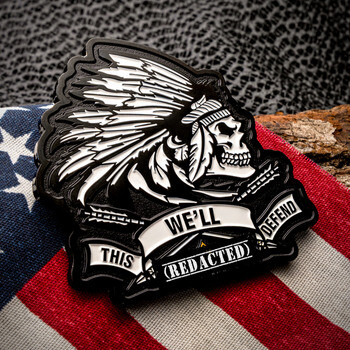 Custom black and white lapel pin featuring a skull in a Native American feather headdress with banner text on an American flag.