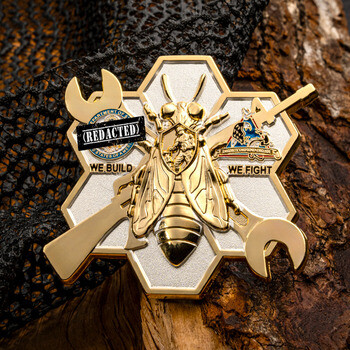 Seabees honeycomb challenge coin featuring a golden bee over crossed wrenches with the motto We Build We Fight.